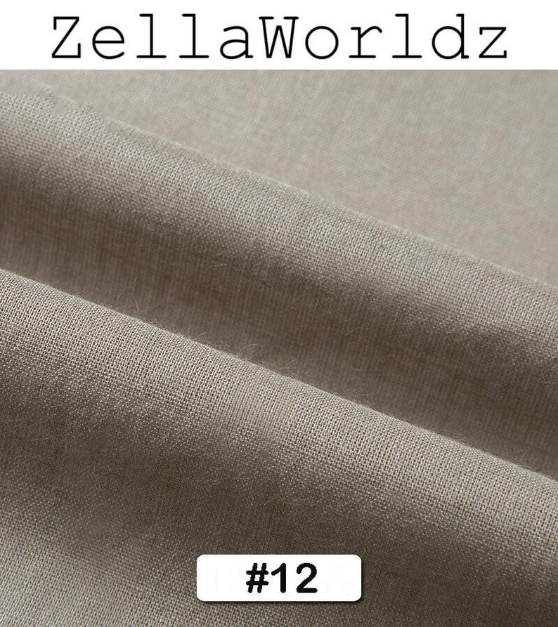 Peut inclure: Gros plan sur une section de tissu beige neutre. Le tissu a un aspect textur&eacute; avec des d&eacute;tails de tissage visibles. Le texte "ZellaWorldz" est en haut et le num&eacute;ro "#12" est dans un rectangle blanc en bas.