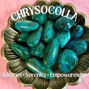 May include: A collection of smooth, green and blue chrysocolla tumbled stones in a gold metal bowl. The stones are arranged in a random pattern. The text "Chrysocolla" is written in white letters on a pink background above the bowl. The text "Wisdom. Serenity. Empowerment" is written in white letters on a pink background below the bowl.