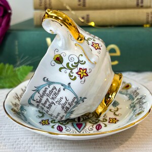May include: A white teacup and saucer with a gold rim and floral pattern. The teacup has a gold handle and the saucer has the text "For All Occasions" written on it. The teacup has the text "Wood Copper, Bronze Pottery, Willow, Jin, Steel, Silk Linen" written on it.