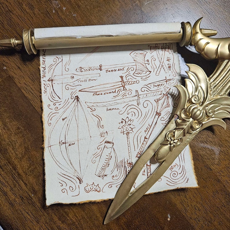 May include: A hand-drawn diagram on a rolled up parchment scroll with a gold-colored bookmark. The diagram shows different types of weapons, including a bow, cross bow, battle axe, short sword, dagger, bolas, and mace. The text on the scroll reads "Steel Wind Strike".