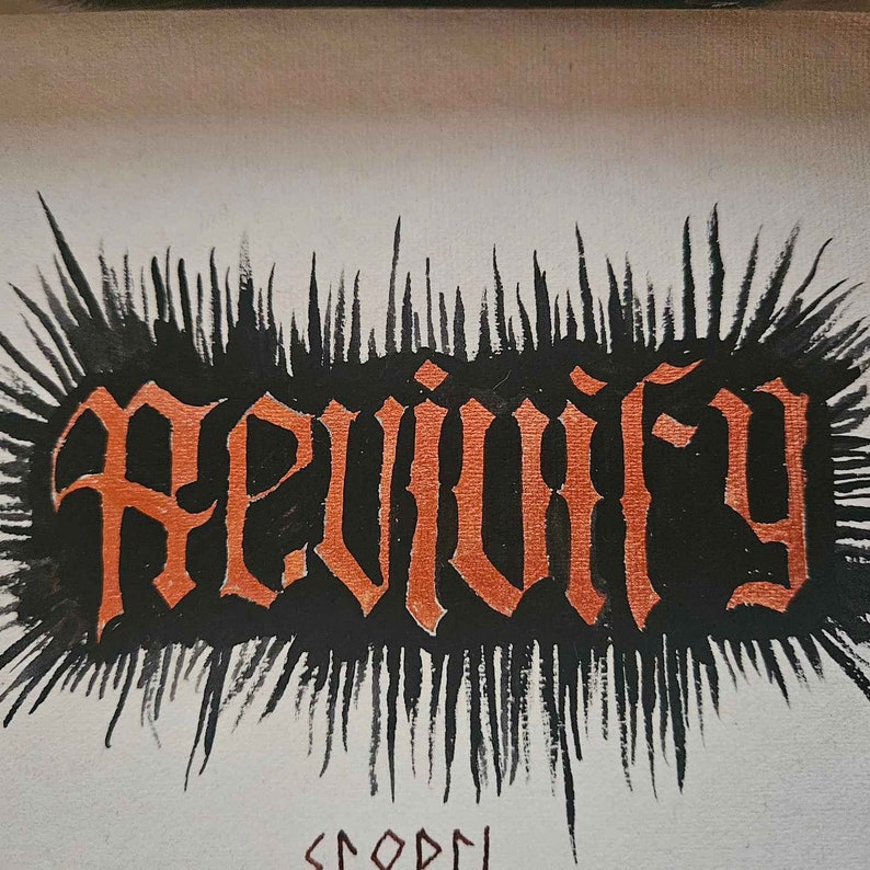 May include: A black and white illustration of the word "Reviving" in a gothic font with orange paint. The word is surrounded by black brushstrokes.