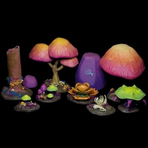 May include: A set of miniature fantasy forest scenery pieces, including a purple rock with a swirl design, a pink and orange mushroom, a green and yellow creature, and a tree with pink and orange mushrooms.