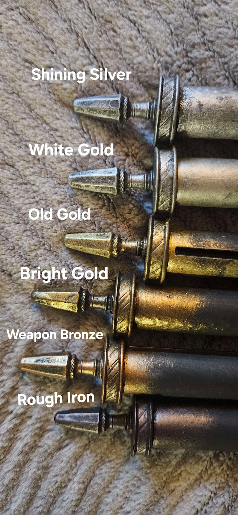 May include: Six metal decorative finials in various finishes, including shining silver, white gold, old gold, bright gold, weapon bronze, and rough iron. The finials are arranged in a row from top to bottom, with the shining silver finial at the top and the rough iron finial at the bottom.