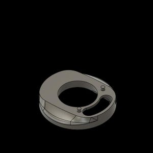 May include: A gray, 3D-rendered object with a circular opening and a smaller, curved opening. The object has a rounded shape with a flat top and several small, circular indentations. The background is solid black.