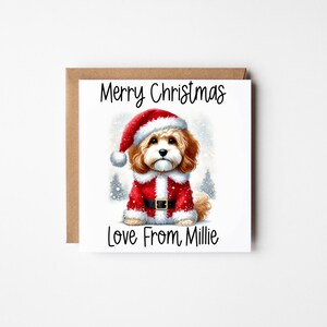 May include: A Christmas card featuring a cute dog wearing a Santa hat and suit. The card reads "Merry Christmas Love From Millie".