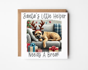 May include: A Christmas card featuring a dog wearing reindeer antlers, lying on a sofa with presents. The card reads "Santa's Little Helper Needs A Break."