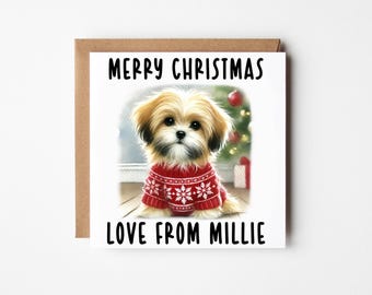 May include: A Christmas card featuring a fluffy dog wearing a red sweater with white snowflake patterns. The card reads "MERRY CHRISTMAS" above and "LOVE FROM MILLIE" below the dog illustration. The card is set against a brown background.
