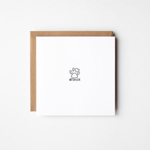 May include: A white card with a black paw print and two hearts above it. The text "ARTSBYLIZUK" is below the paw print.