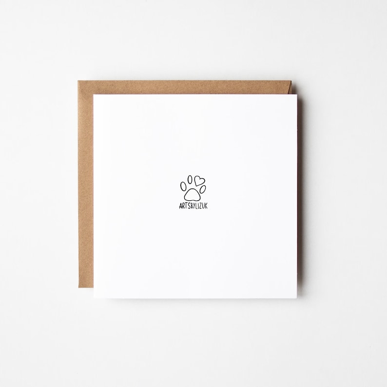 May include: A white card with a black paw print and two hearts above it. The text "ARTSBYLIZUK" is below the paw print.