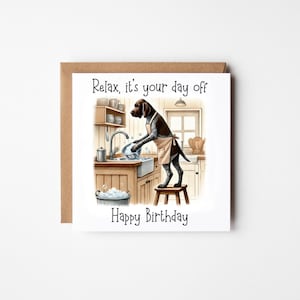 May include: A square greeting card with a brown envelope. The card features an illustration of a dog wearing an apron, washing dishes in a kitchen. Text on the card reads "Relax, it's your day off" and "Happy Birthday".