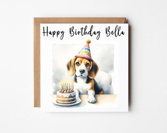 May include: A birthday card featuring a watercolor illustration of a beagle puppy wearing a party hat and sitting next to a birthday cake with candles. The card says "Happy Birthday Bella".