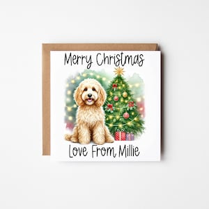 May include: A Christmas card featuring a golden doodle dog sitting in front of a decorated Christmas tree. The card reads "Merry Christmas Love From Millie".