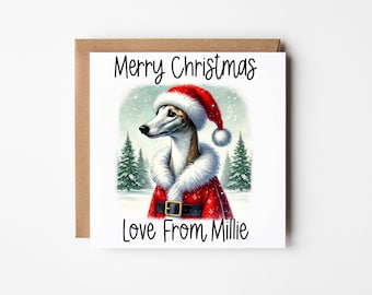 Peut inclure: Une carte de Noël représentant un lévrier portant un bonnet de Père Noël et un costume de Père Noël rouge et blanc. La carte porte l'inscription "Joyeux Noël Avec amour de Millie".