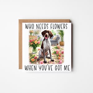 May include: Square greeting card featuring a brown and white dog illustration with flowers. The text on the card says "WHO NEEDS FLOWERS WHEN YOU'VE GOT ME". The card is presented with a brown envelope.