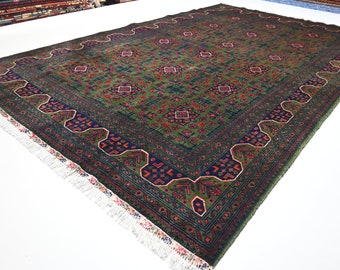 May include: A green, blue, and red patterned rug with a fringe border. The rug has a traditional design with intricate details.