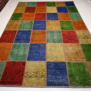 May include: A colorful patchwork rug with a variety of colors and patterns, including red, blue, green, and yellow. The rug is made of different pieces of fabric that have been sewn together.