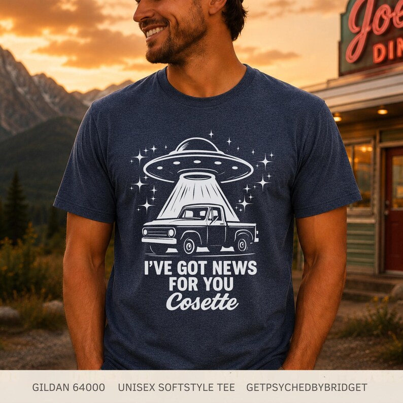May include: A heather navy blue short-sleeve t-shirt featuring a white graphic of a pickup truck being abducted by a UFO. The text reads I'VE GOT NEWS FOR YOU Cosette. The shirt is a Gildan 64000 unisex softstyle tee by GetPsychedByBridget.