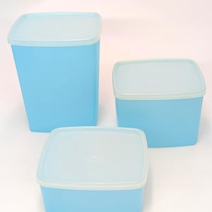 May include: A set of three ceramic mugs with a speckled, matte finish. The mugs are in shades of cream, light gray, and dark gray. Each mug has a simple, minimalist design, perfect for coffee or tea.