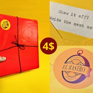 May include: A square package wrapped in bright red paper, tied with thin black string, and featuring a yellow circular sticker with the text El Rastro. A yellow envelope contains a note with the text Show it off! Write the next novel!