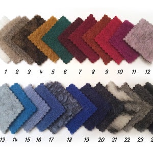 May include: A swatch card displaying 24 fabric samples. The samples are arranged in two rows of 12. Each sample is a different colour and texture. The numbers 1 to 24 are printed below the samples.