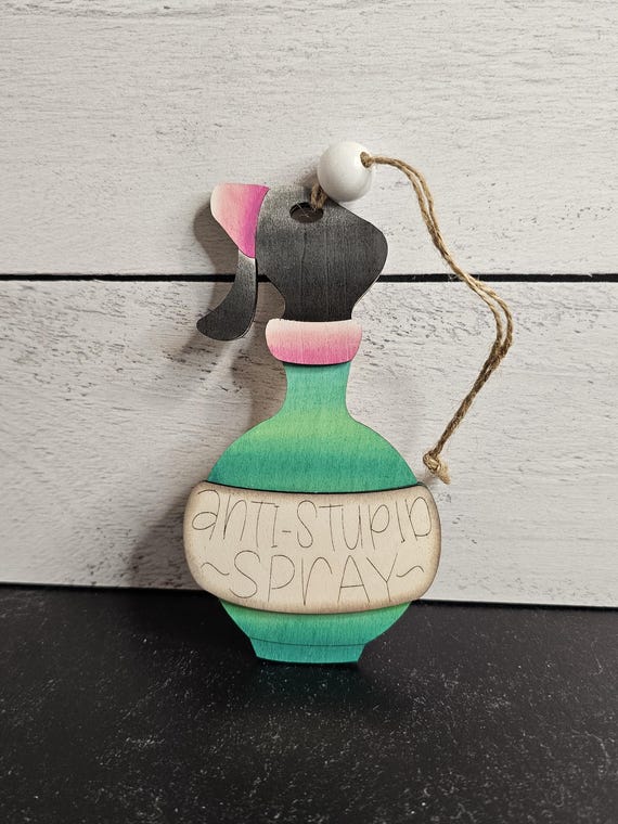 Laser-cut wood ornament that roasts the recipient's intelligence — snarky, shareable, and actually handmade with a real material.