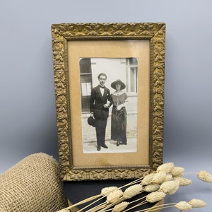 Vintage photo frame early 20th century, antique frame with vintage photo of a standing couple, gilded frame with floral pattern, collecting