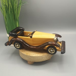 Vintage wooden car, antique collectible car early 20th century, old car home decoration, retro car collection, car shelves, showcases decor