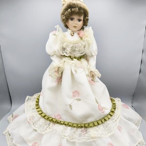 Vintage porcelain doll in luxurious silk dress with roses, Victorian doll with violet eyes, doll collection as a chic gift for any occasion