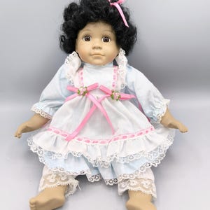 Vintage porcelain doll, sitting doll collection, doll with dark skin and black curly hair, doll retro dress with ribbons, collectors gift