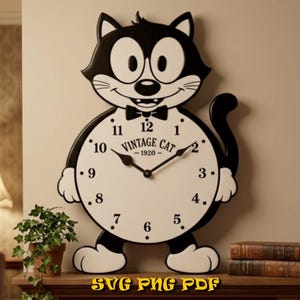 May include: A black and white wall clock shaped like a cartoon cat with large eyes, a bowtie, and a round clock face. The face features black numbers from 1 to 12, black hands, and the text VINTAGE CAT 1920 printed in the center of the dial.