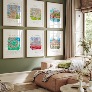 May include: Six framed watercolor paintings of different cities around the world. Each painting features a cityscape with a watercolor wash background. The cities are Mexico, Italy, Norway, Jamaica, Canada, and Austria.