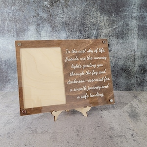 May include: Wooden picture frame with a quote about friendship: "In the vast sky of life, friends are the runway lights guiding you through the fog and darkness - essential for a smooth journey and a safe landing."