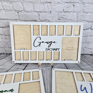 May include: White wooden photo frame with cutouts for pictures. The frame has a white border and is designed to hold photos of a child's school years, from pre-K through senior year. The frame has the words "The days are long but the years are short" inscribed on it. The frame is personalized with the name "Gauge Zachary".