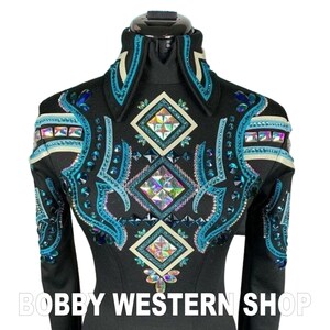 May include: A black long-sleeve shirt featuring a high collar and intricate embellishments of teal, blue, and iridescent crystals arranged in geometric diamond patterns and swirling lines. The text BOBBY WESTERN SHOP is printed at the bottom.