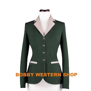 May include: A dark green riding jacket with a light brown collar and trim. The jacket has a fitted waist and a single-breasted closure with five buttons. The jacket has two pockets on the front and a Bobby Western Shop logo on the bottom.