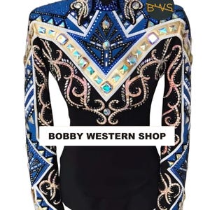 May include: A black long-sleeve shirt featuring a blue, white, and gold geometric pattern across the chest and sleeves, adorned with numerous iridescent crystals. The text BOBBY WESTERN SHOP is printed in black on a white rectangular background.