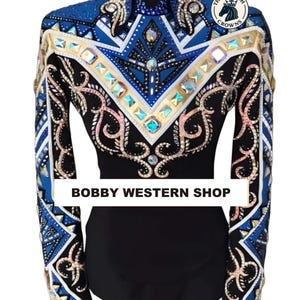 May include: A black long-sleeve shirt featuring a blue, white, and gold geometric pattern across the chest and sleeves, adorned with numerous iridescent crystals. The text BOBBY WESTERN SHOP is printed in black on a white horizontal bar across the front.