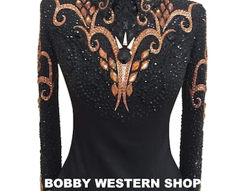 May include: A black long-sleeve shirt featuring a high collar, adorned with intricate copper-colored crystal patterns and dense black beadwork. The text BOBBY WESTERN SHOP is printed in white across the lower front of the garment.