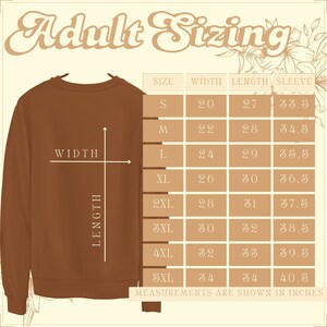 May include: A brown sweatshirt with a size chart showing measurements in inches for different sizes: S, M, L, XL, 2XL, 3XL, 4XL, and 5XL. The chart shows width, length, and sleeve length.