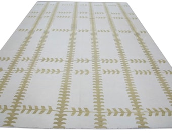 May include: White rug with a geometric pattern of beige arrows and lines.