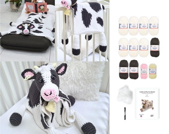 May include: A collection of handmade crochet items, including a cow-shaped blanket, a cow-shaped pillow, and a large cow plushie. The blanket and pillow feature black and white patterns. Also included are yarn skeins in various colors and a pattern booklet.