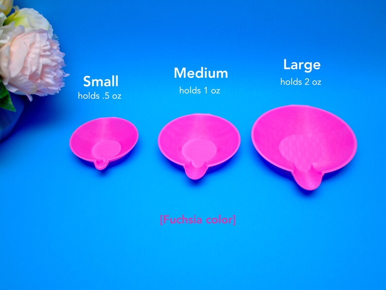 May include: Three fuchsia-colored, small, medium, and large, round trays with a small handle. The small tray holds 0.5 oz, the medium holds 1 oz, and the large holds 2 oz. The text reads "Small holds .5 oz", "Medium holds 1 oz", and "Large holds 2 oz".