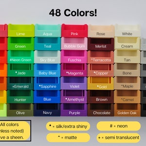 May include: A chart of 48 different colors of plastic containers. The colors are arranged in rows and columns. Each container has a label with the color name. Some colors have additional markings indicating if they are extra shiny, matte, or semi-translucent.