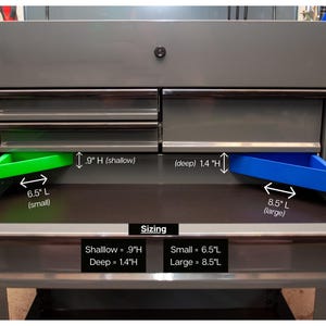 May include: A gray metal tool chest with open drawers revealing green and blue trays. The small tray is 6.5 inches long and the large tray is 8.5 inches long. The shallow drawer is 0.9 inches high and the deep drawer is 1.4 inches high.