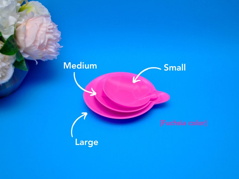 May include: Three fuchsia-colored, stackable, round lids labeled "Small", "Medium", and "Large". The lids are on a bright blue background. The text "[Fuchsia color]" is also present.