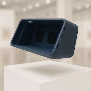 Peut inclure: Un étui rectangulaire bleu marine au design incurvé. L'étui comporte deux carrés noirs à l'intérieur et de petits trous sur le côté. L'étui est présenté sur un socle blanc.