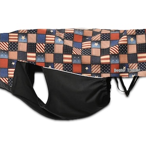 May include: A black fabric face mask with a red, white, and blue patchwork design featuring stars and stripes. The fabric has the text "Double Trouble" printed on it.