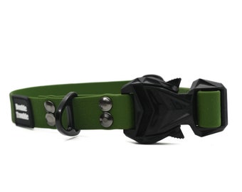 May include: A green rubber dog collar with a black buckle and metal accents. The collar has the text "Bark & Tumble" printed on it.