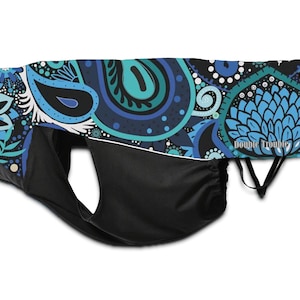 May include: A blue and green paisley patterned dog diaper with black elastic straps and the text "Double Trouble" printed on the side.