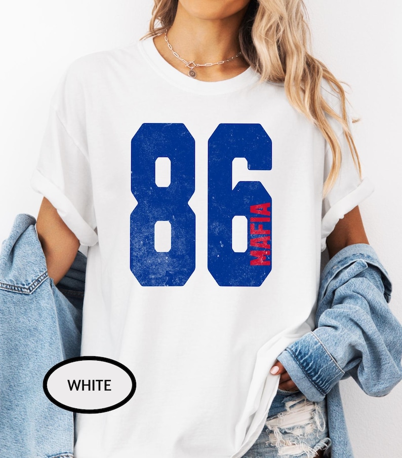 May include: White t-shirt with a blue and red graphic of the number 86 with the word "Mafia" vertically written inside the 6.